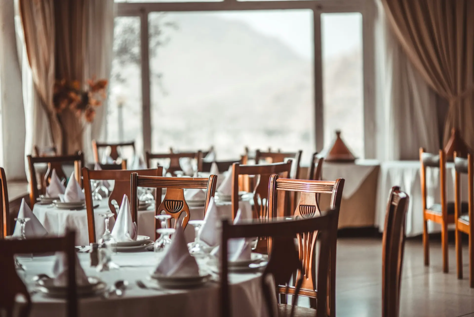 Salón de restaurante elegante con mesas listas para recibir reservas